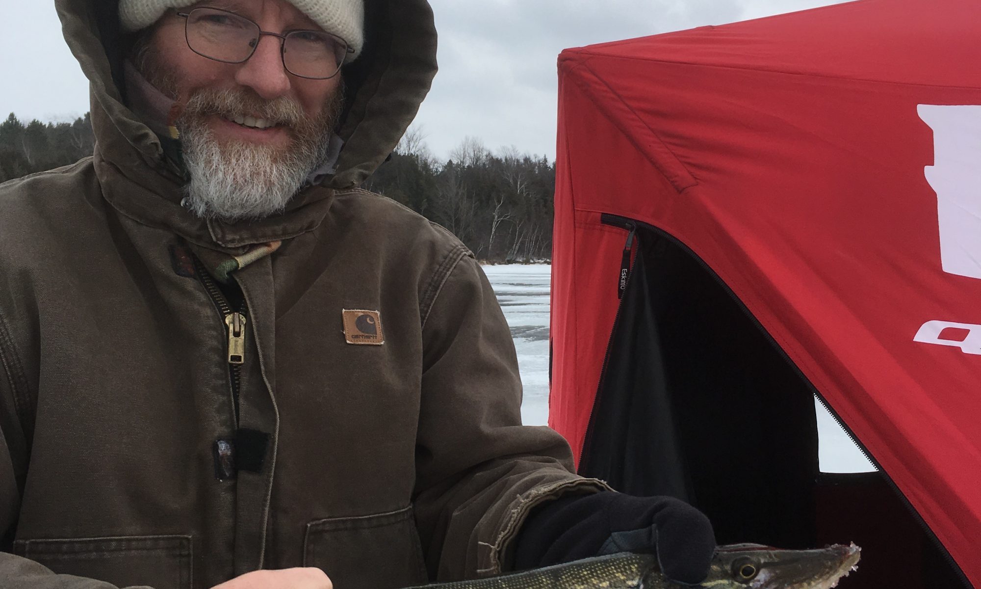 Charles holding a pike caught in Toronto